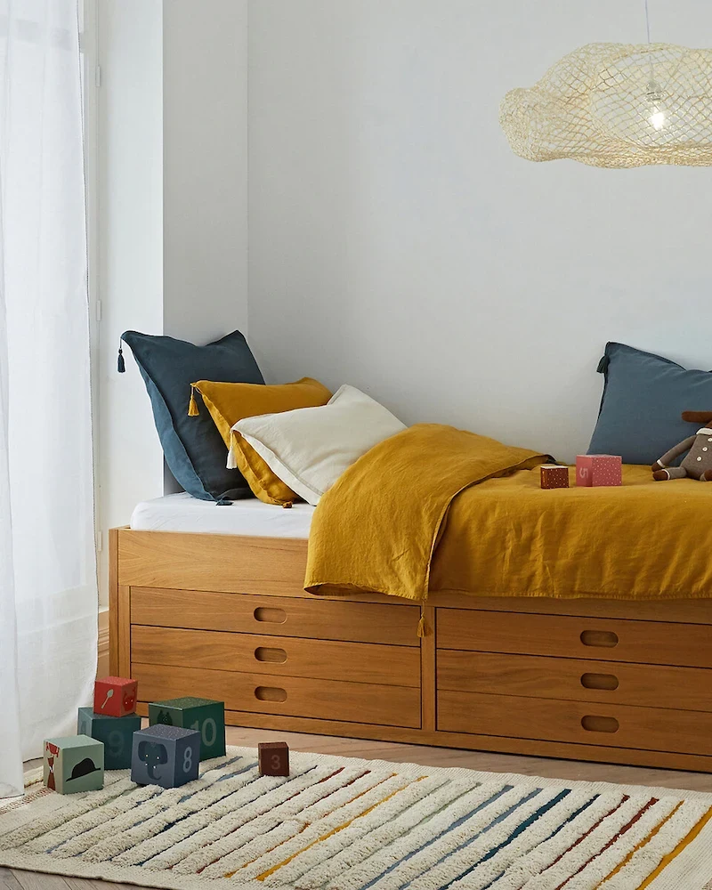 Lit plateforme Octavo en plaqué chêne avec quatre tiroirs dans une chambre d'enfant