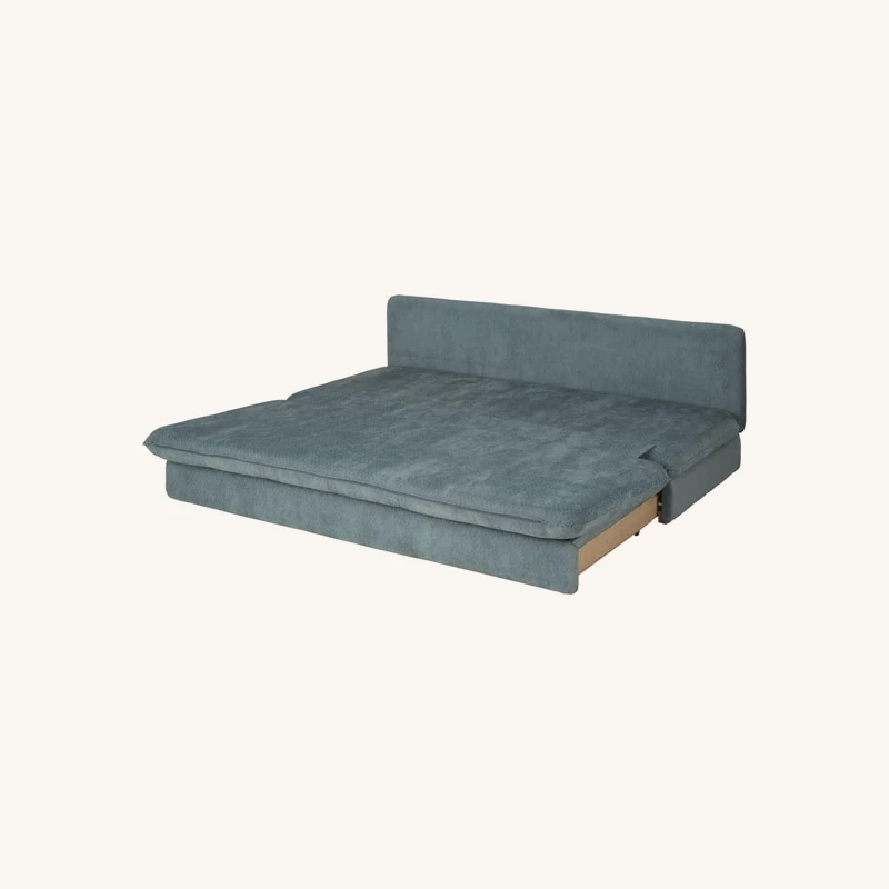 Canapé convertible 2/3 places bleu canard chez Maisons du Monde